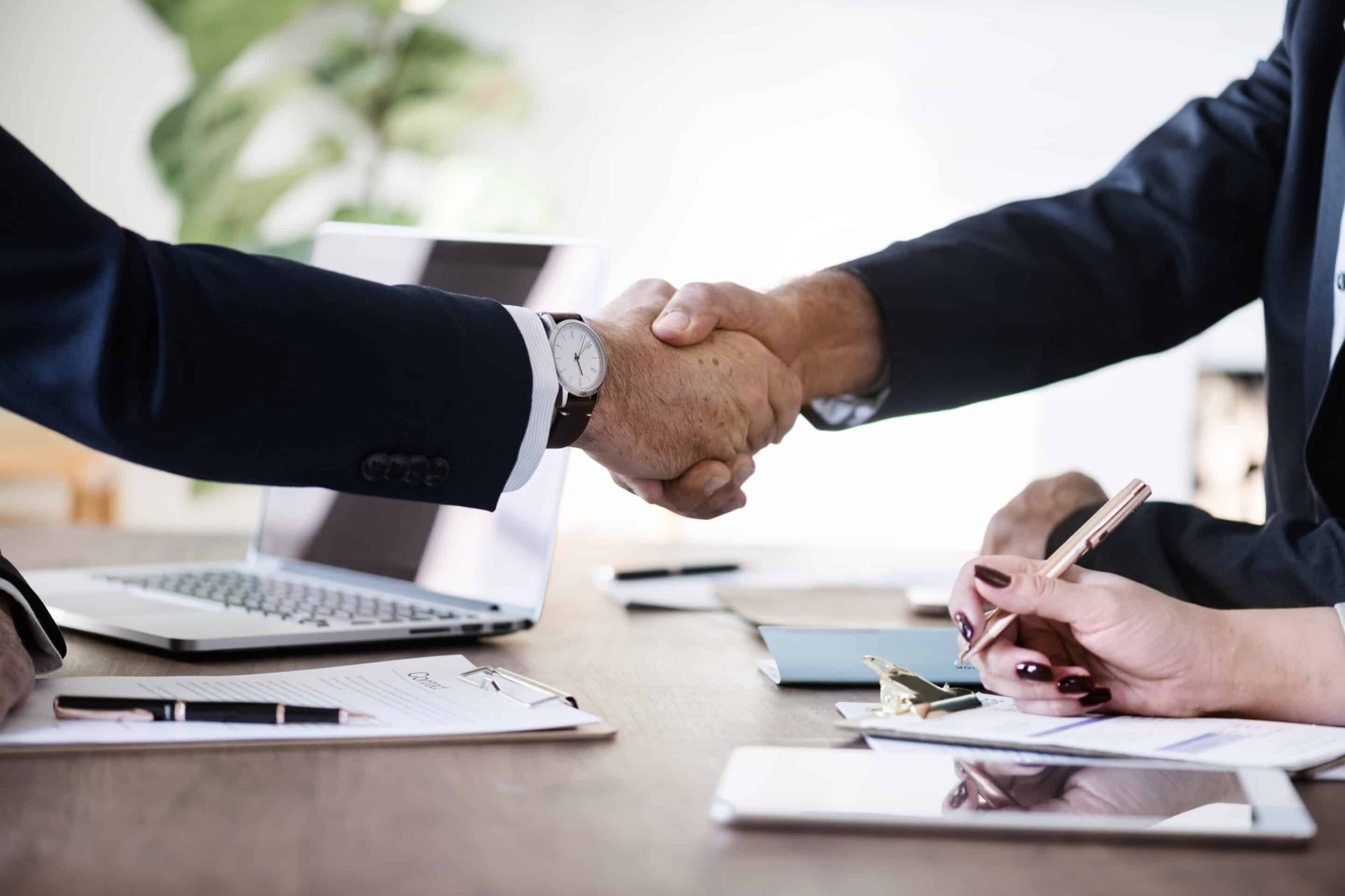 business people shaking hands together scaled